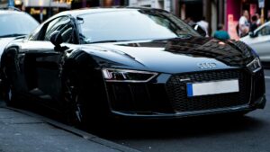 black audi r8 parked in a busy street